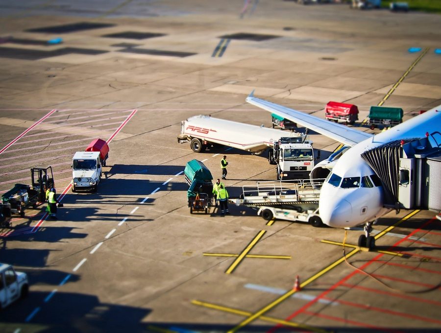 Ground crew loading freight onto an aircraft on the apron