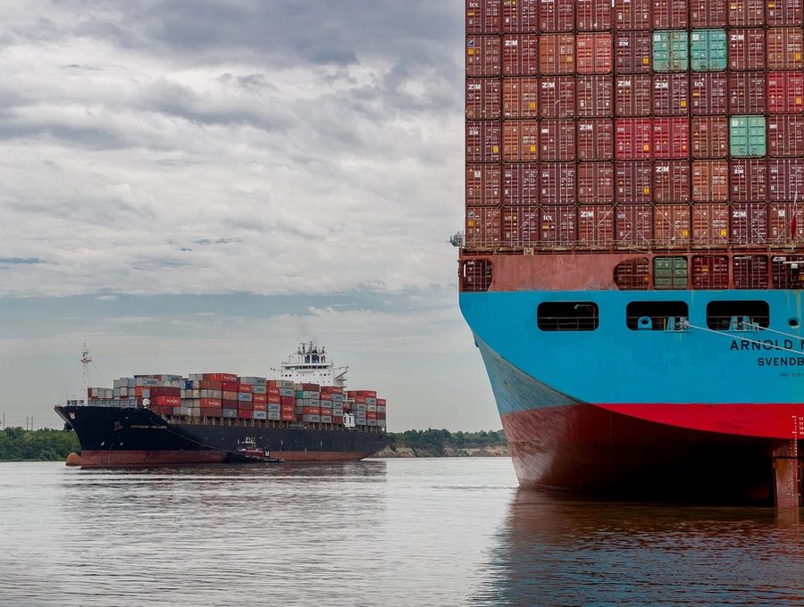 A loaded container ship approaching a port terminal