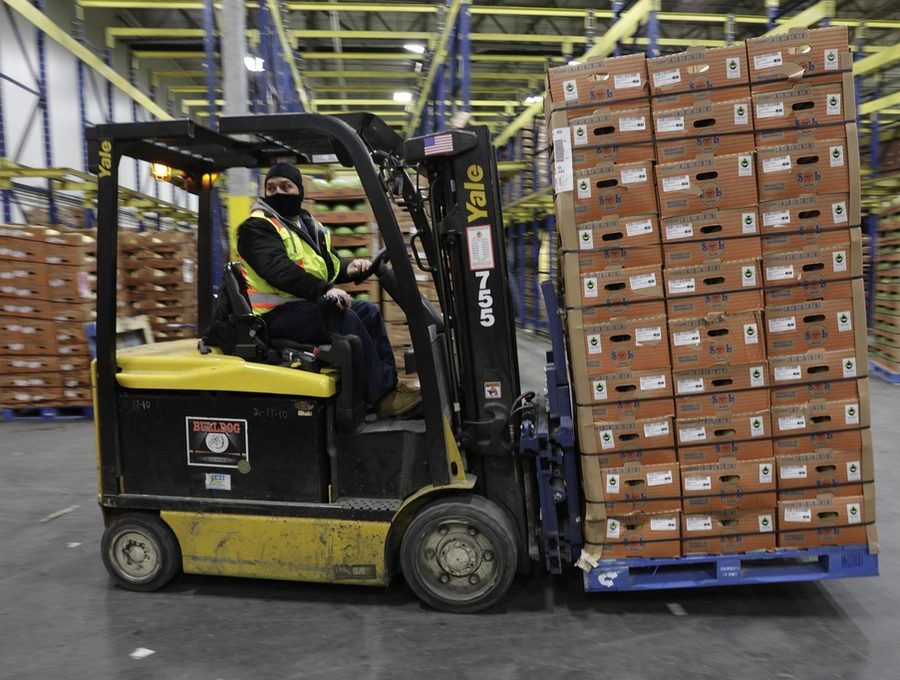 A forklift moving palletised goods inside a distribution warehouse